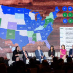 A panel of six people sits on a stage in front of a large screen displaying a map of the United States. The map is color-coded to show the status of sports betting legislation in various states.